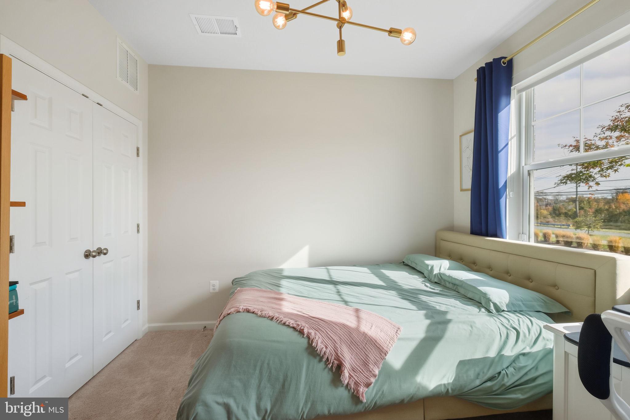 15635 Trolley Lane Silver Spring, MD 20906 - Photo 5 of 41 a bed sitting in a bedroom next to a window