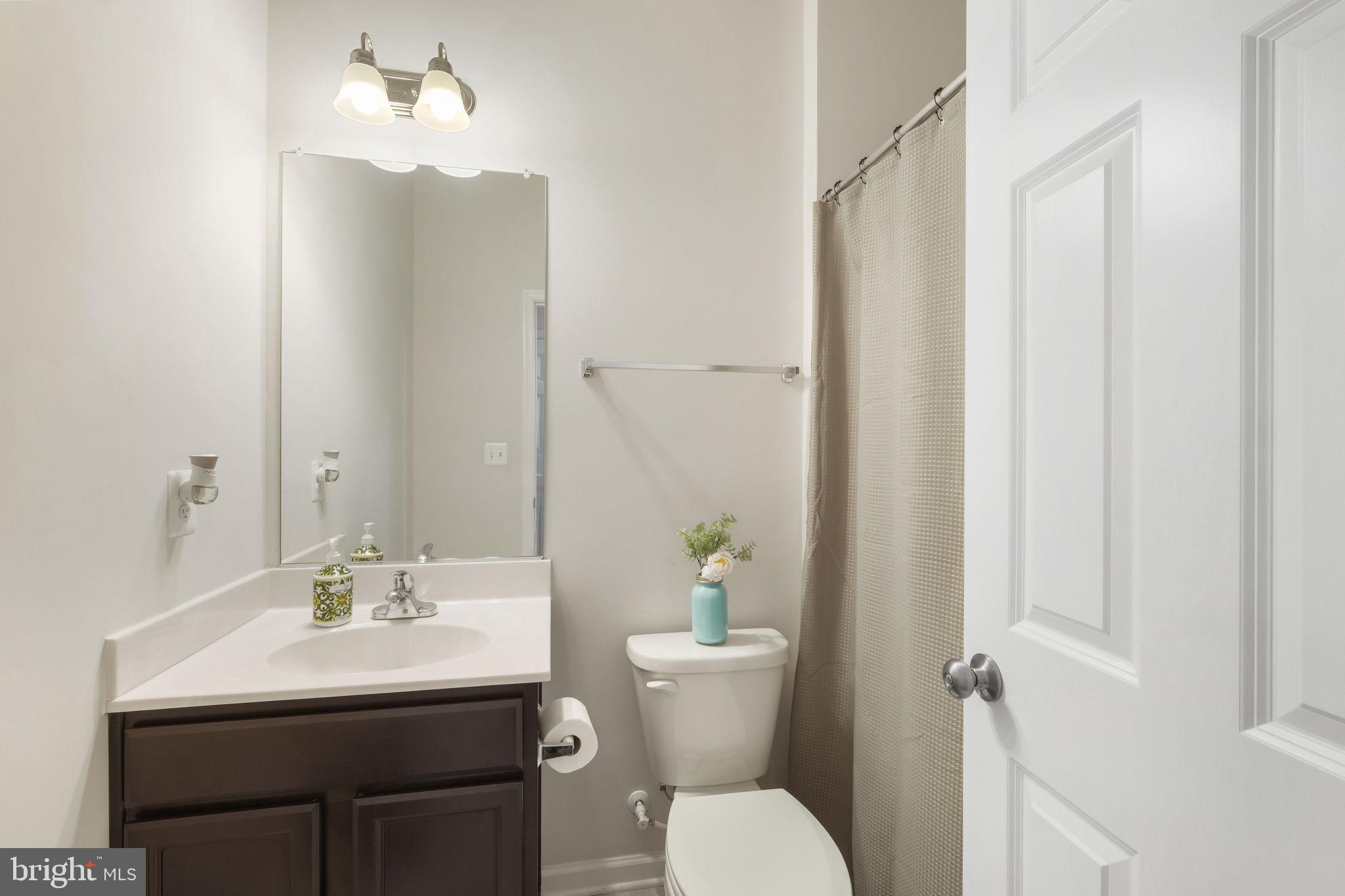15635 Trolley Lane Silver Spring, MD 20906 - Photo 6 of 41 a bathroom with a toilet a sink and a mirror
