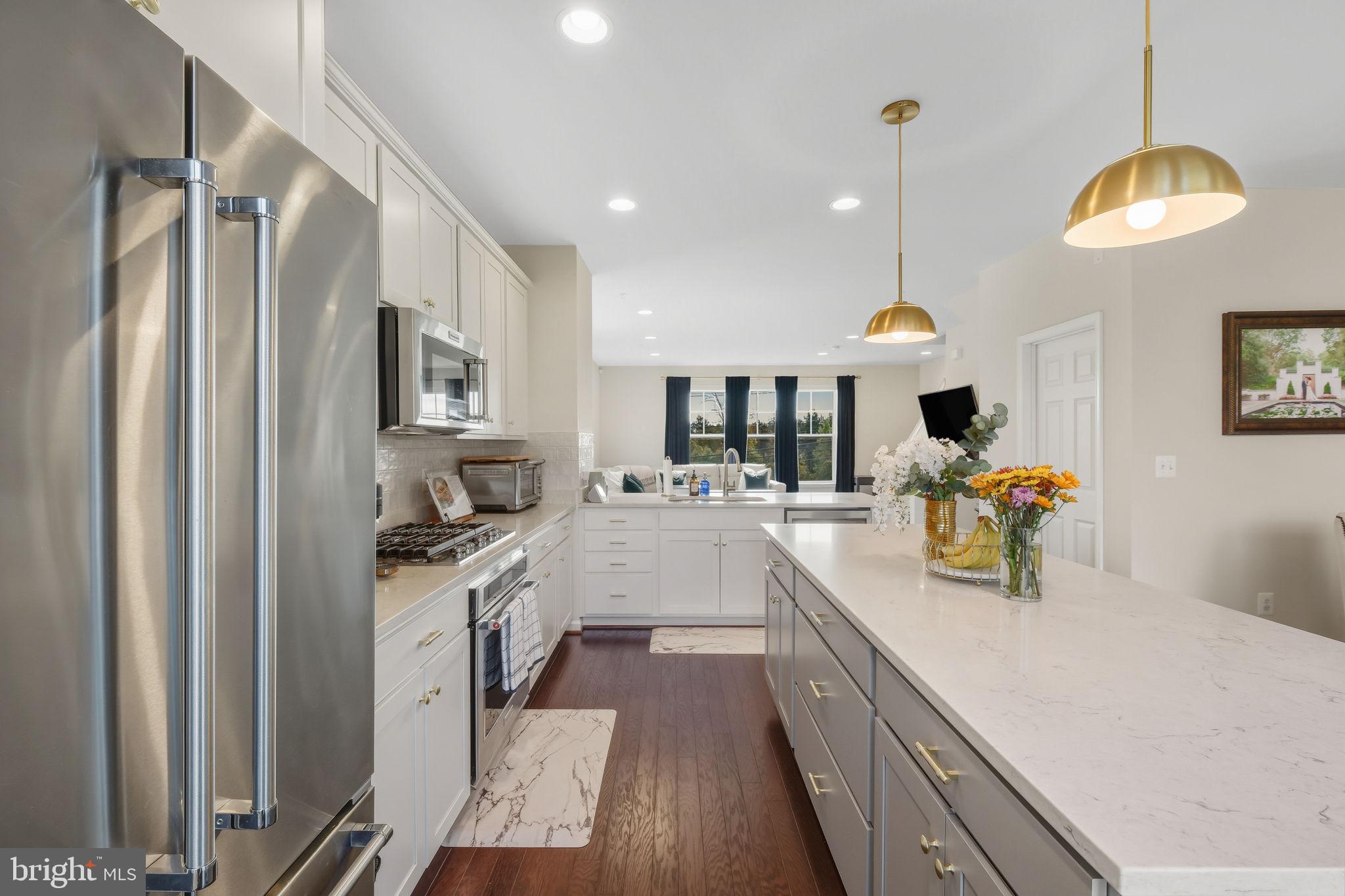 15635 Trolley Lane Silver Spring, MD 20906 - Photo 10 of 41 a large white kitchen with lots of counter space and stainless steel appliances