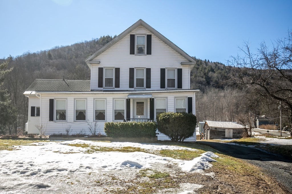 231 River Road Florida, MA 01367 - Photo 1 of 40 a front view of a house with a yard covered with snow in the background