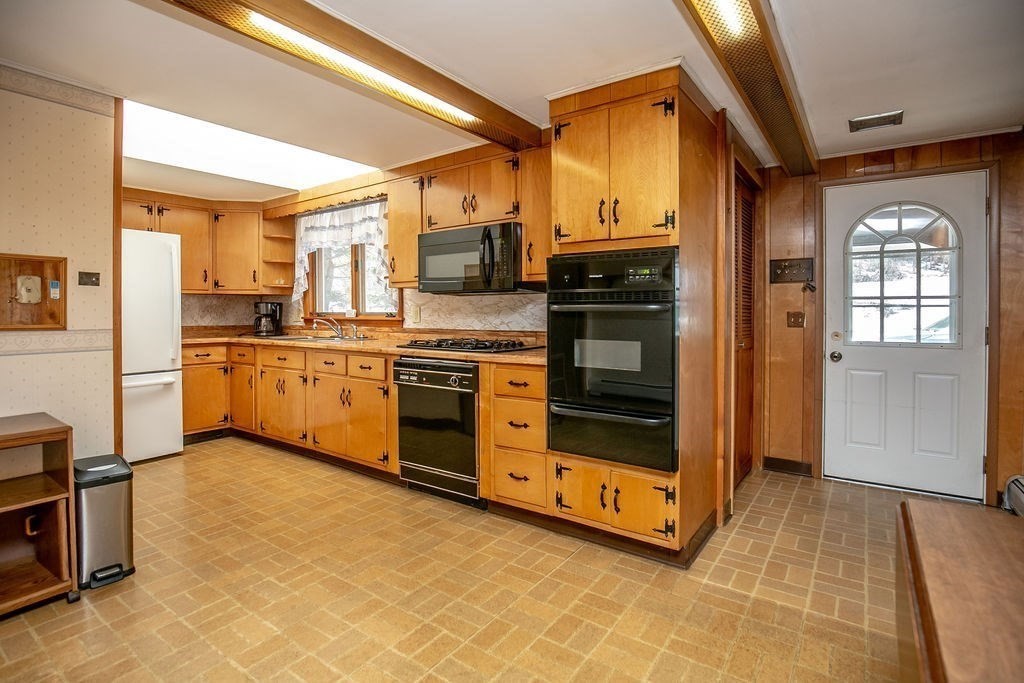 231 River Road Florida, MA 01367 - Photo 9 of 40 a kitchen with stainless steel appliances granite countertop a stove a sink and a refrigerator
