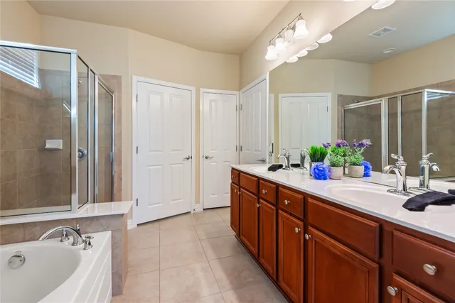 a spacious bathroom with a double vanity sink mirror and shower