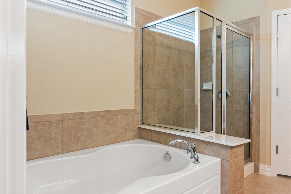 106 Trinity Lane Georgetown, TX 78633 - Photo 17 of 24 a bathroom with a bathtub and shower