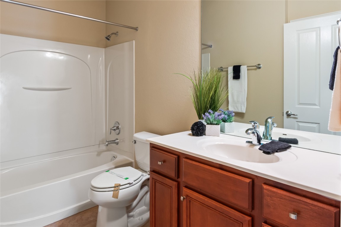 106 Trinity Lane Georgetown, TX 78633 - Photo 5 of 24 a bathroom with a sink a toilet and shower