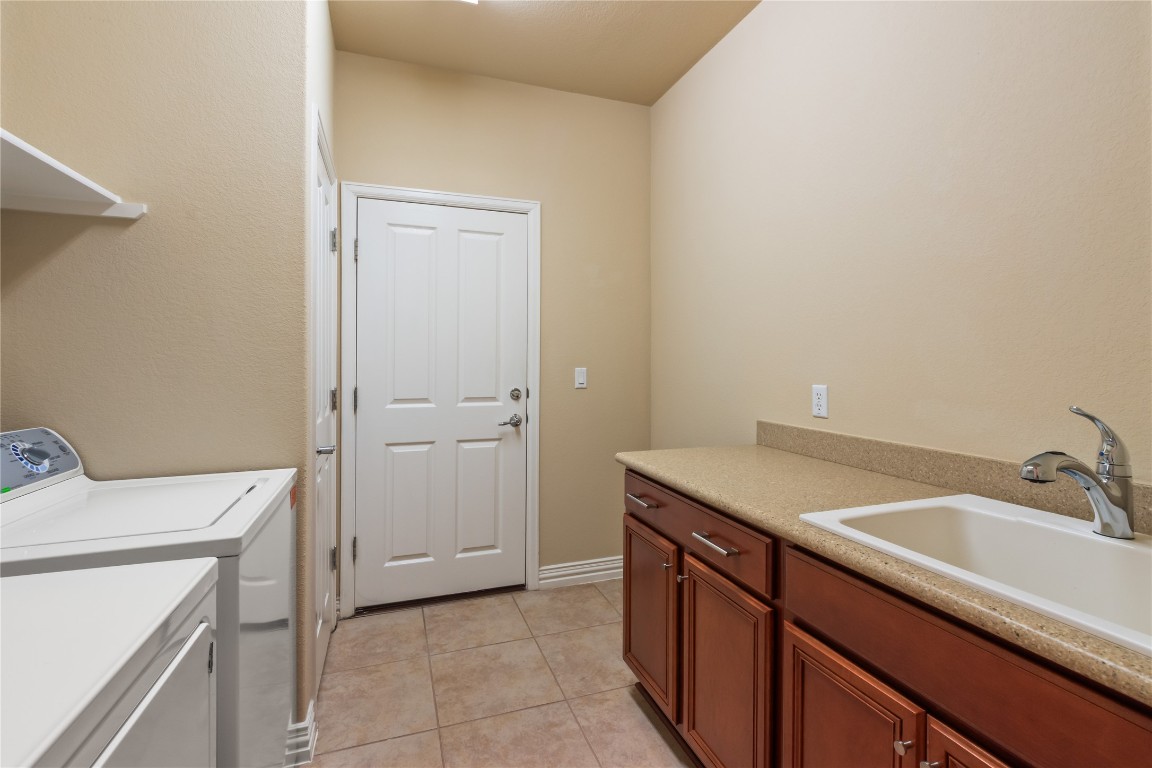 106 Trinity Lane Georgetown, TX 78633 - Photo 6 of 24 a utility room with a sink washer and dryer