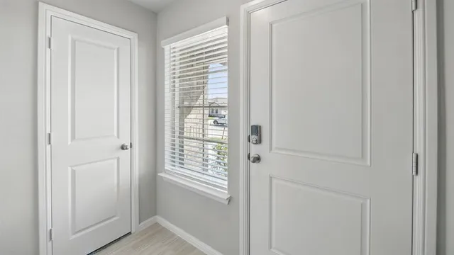 a view of a hallway with wooden floor