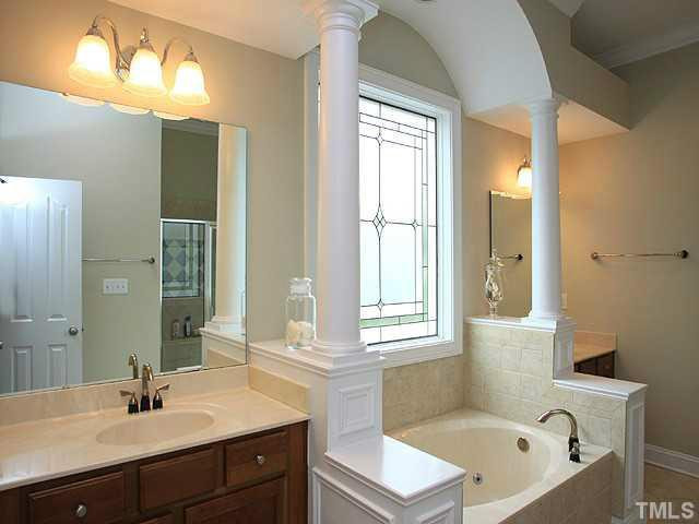 2259 Clayette Court Raleigh, NC 27612 - Photo 17 of 25 a bathroom with a tub sink and mirror