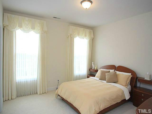 2259 Clayette Court Raleigh, NC 27612 - Photo 19 of 25 a bedroom with a bed and a window