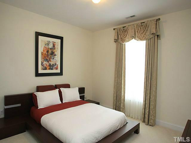 2259 Clayette Court Raleigh, NC 27612 - Photo 21 of 25 a bedroom with a bed and a painting on the wall