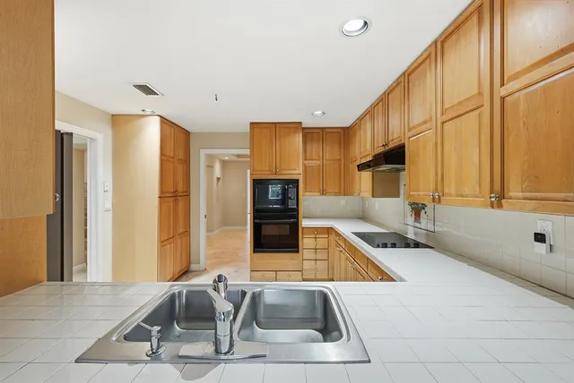 an empty room with a ceiling fan and shower