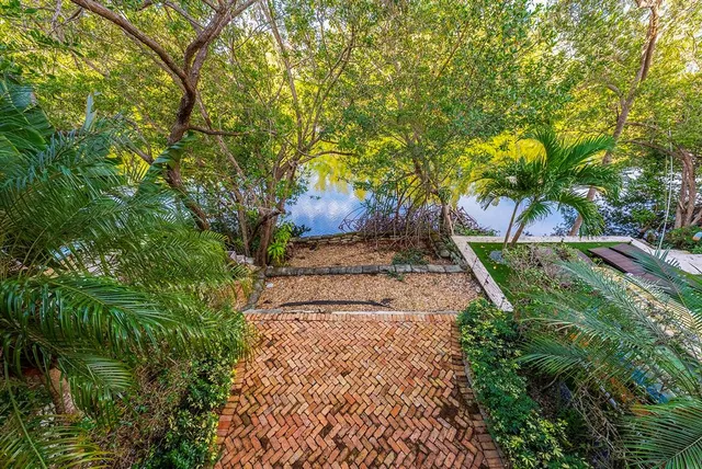 a view of a big room with chandelier fan and windows
