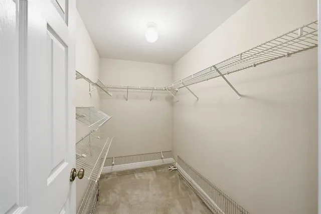 a view of a room with an empty space and wooden floor