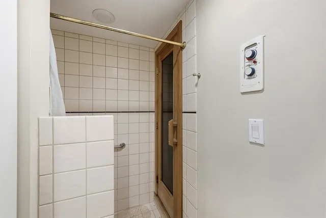 a view of a balcony with chairs potted plants