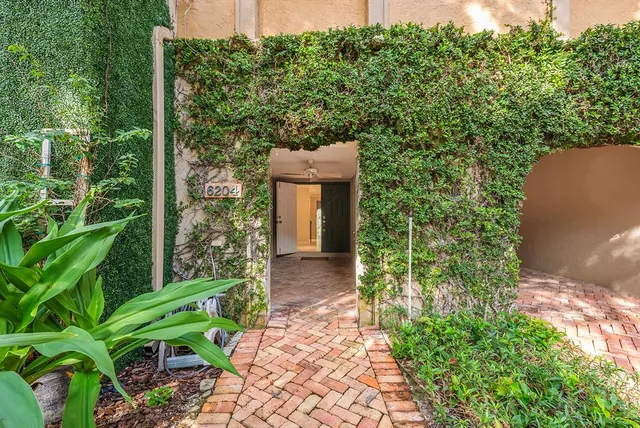 a front view of a building with a garden