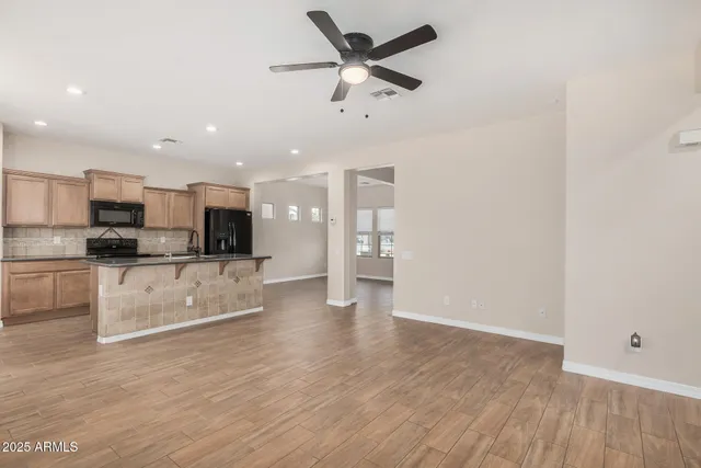 a view of kitchen with sink microwave refrigerator and stove