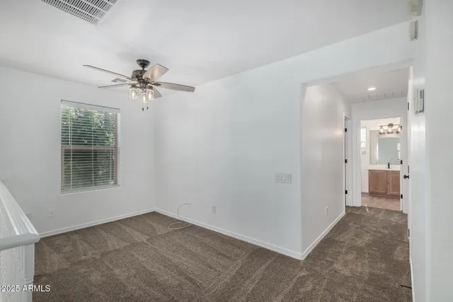 an empty room with a bathroom and a sink