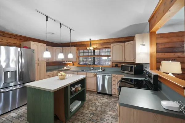 a kitchen with a table and chairs