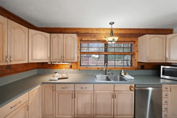 a kitchen with a sink stove and cabinets