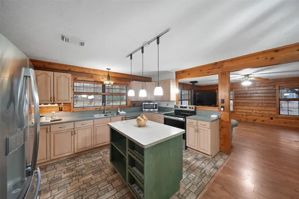 a kitchen with granite countertop a sink and white cabinets