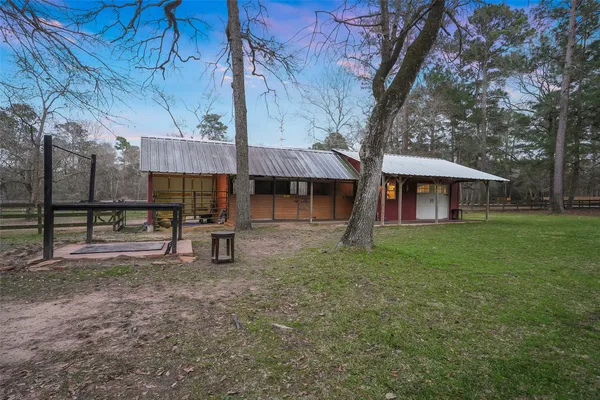 a view of a house with backyard and a tree