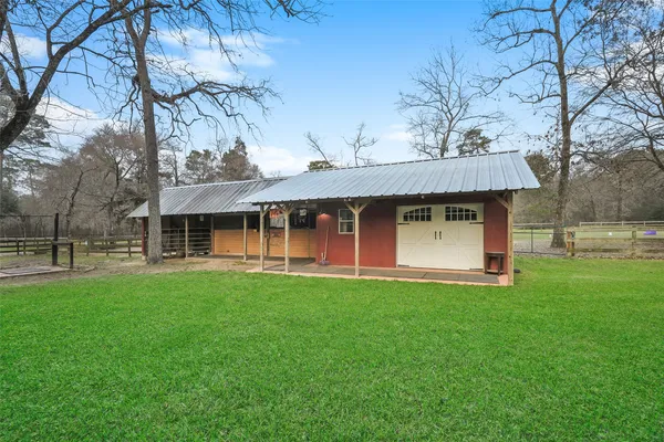 a view of a yard with wooden fence