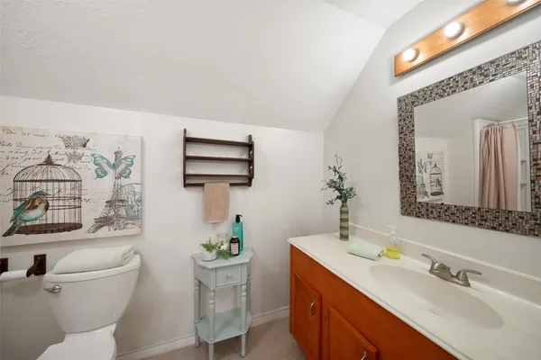 a white toilet sitting next to a bathroom sink and tub
