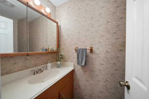 a view of a house with backyard and trees