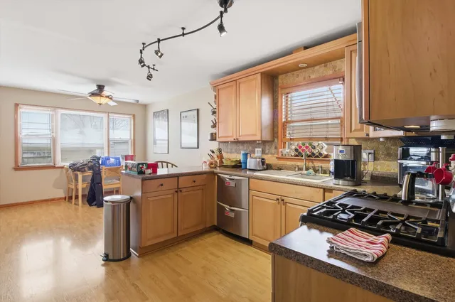 a kitchen with sink refrigerator and window