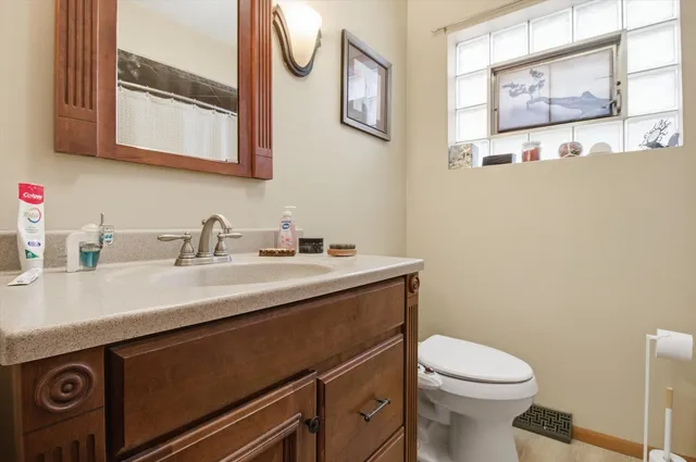 a bathroom with a sink a toilet and a mirror