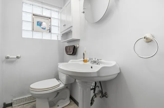 a bathroom with a sink a toilet and mirror