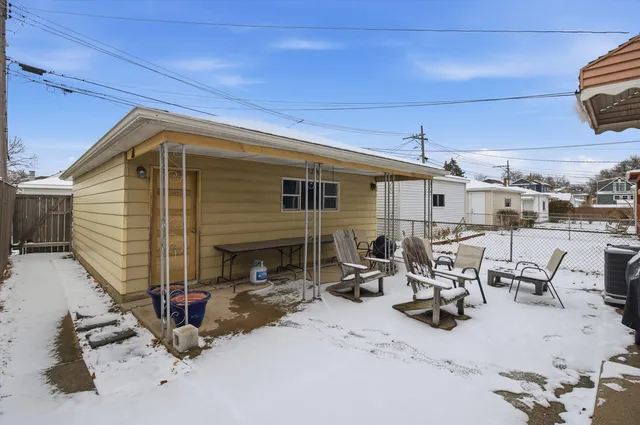 a view of a patio with a table and chairs under an umbrella