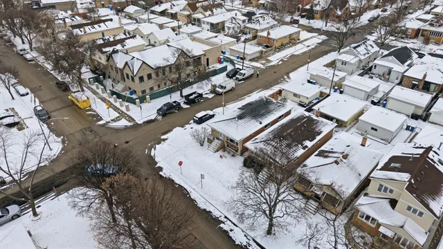 an aerial view of a house with a mountain