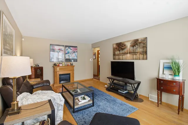 a living room with furniture a flat screen tv and a table
