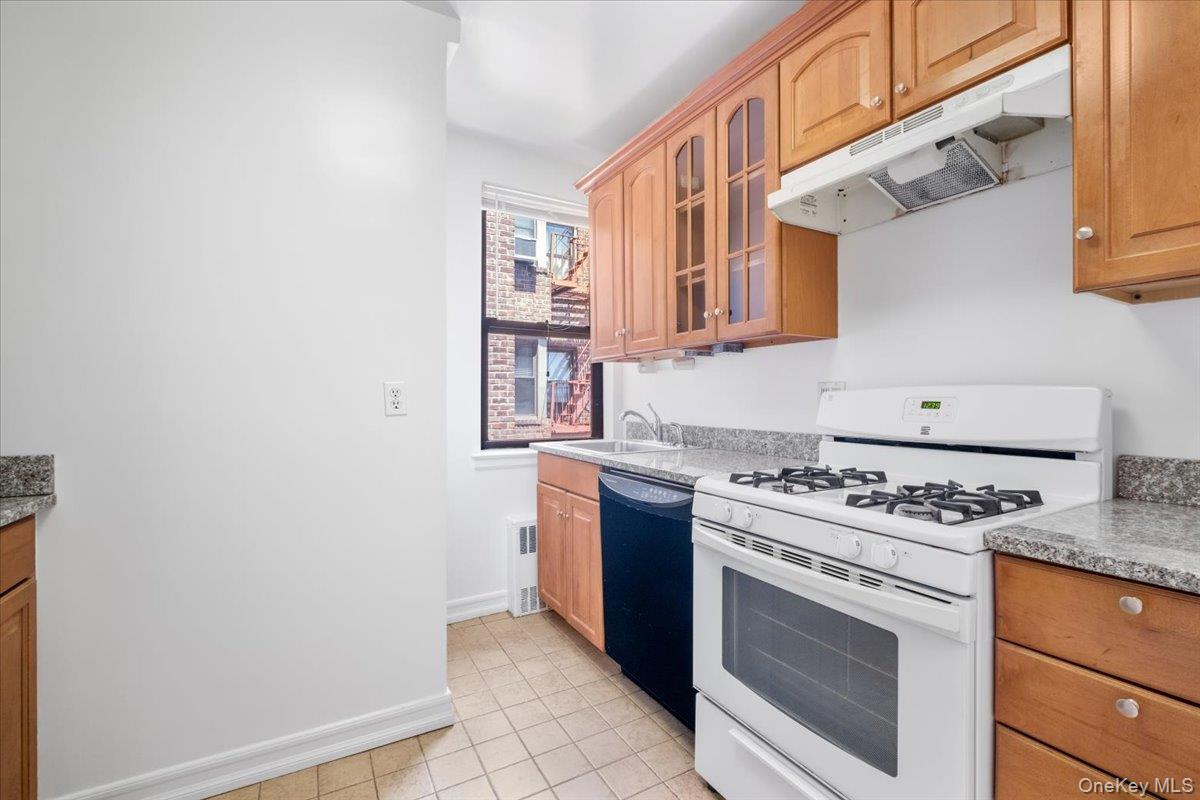 142 Garth Road, Unit 5K Scarsdale, NY 10583 - Photo 10 of 33 Galley kitchen with granite countertops