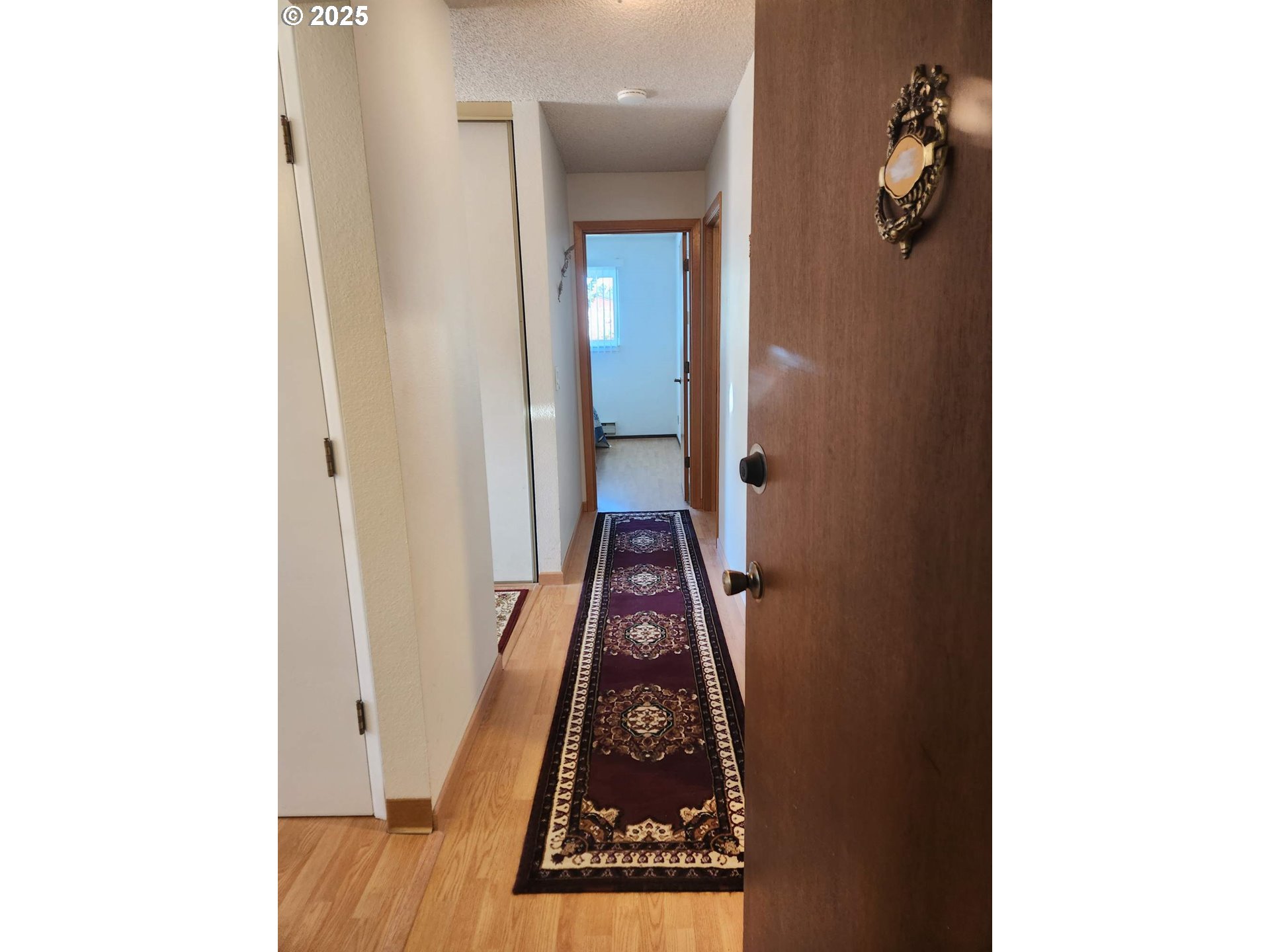 950 Evergreen Road, Unit 229 Woodburn, OR 97071 - Photo 2 of 33 a view of a hallway with wooden floor