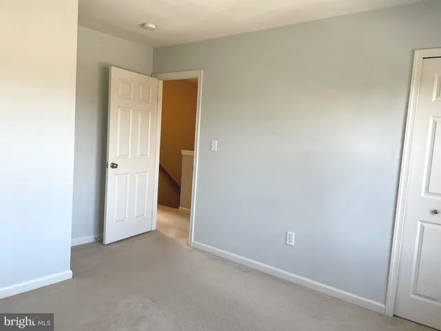 an empty room with a empty space and windows