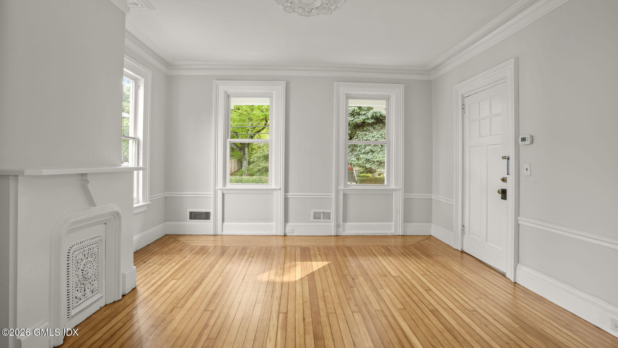 43 Church Street, Unit 1 Greenwich, CT 06830 - Photo 6 of 17 an empty room with wooden floor and windows