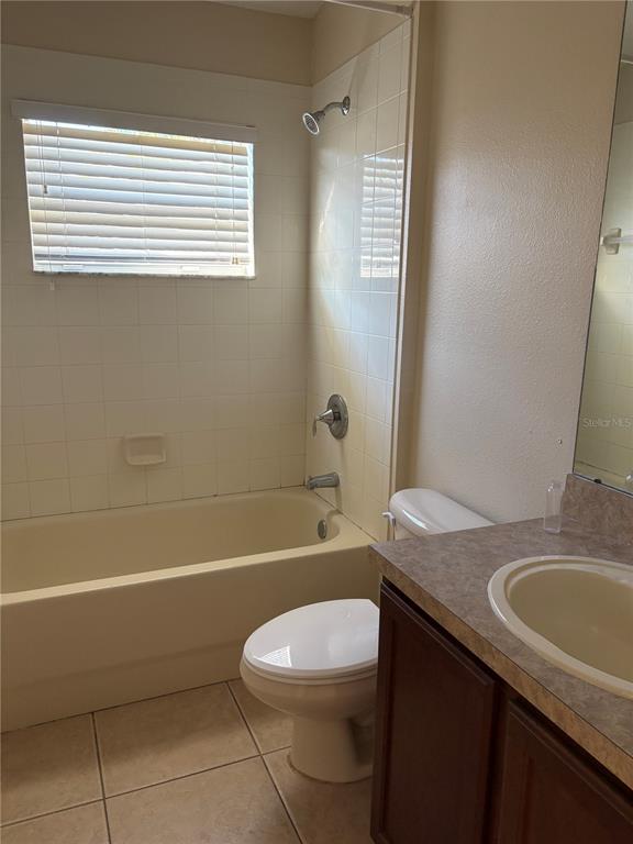 3878 Prescott Loop Lakeland, FL 33810 - Photo 12 of 12 a bathroom with a granite countertop sink toilet a mirror and bathtub