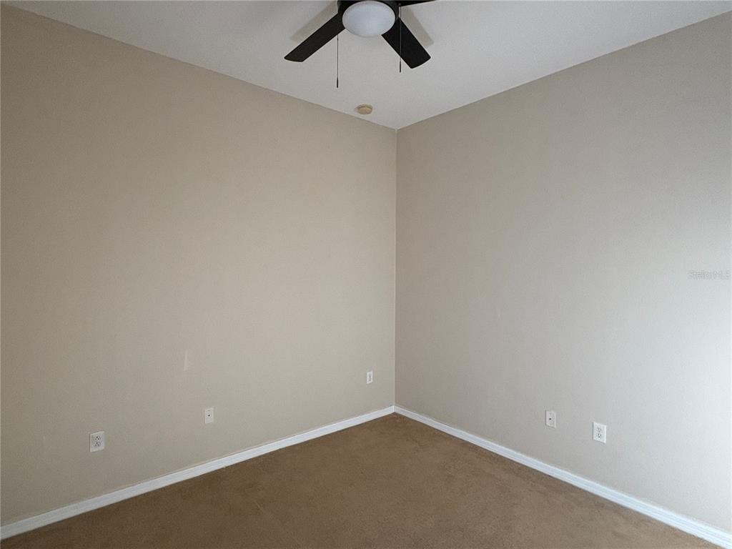 3878 Prescott Loop Lakeland, FL 33810 - Photo 6 of 12 an empty room with a ceiling fan and window