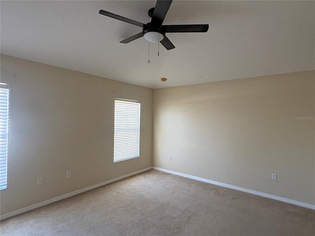 3878 Prescott Loop Lakeland, FL 33810 - Photo 7 of 12 an empty room with windows and fan