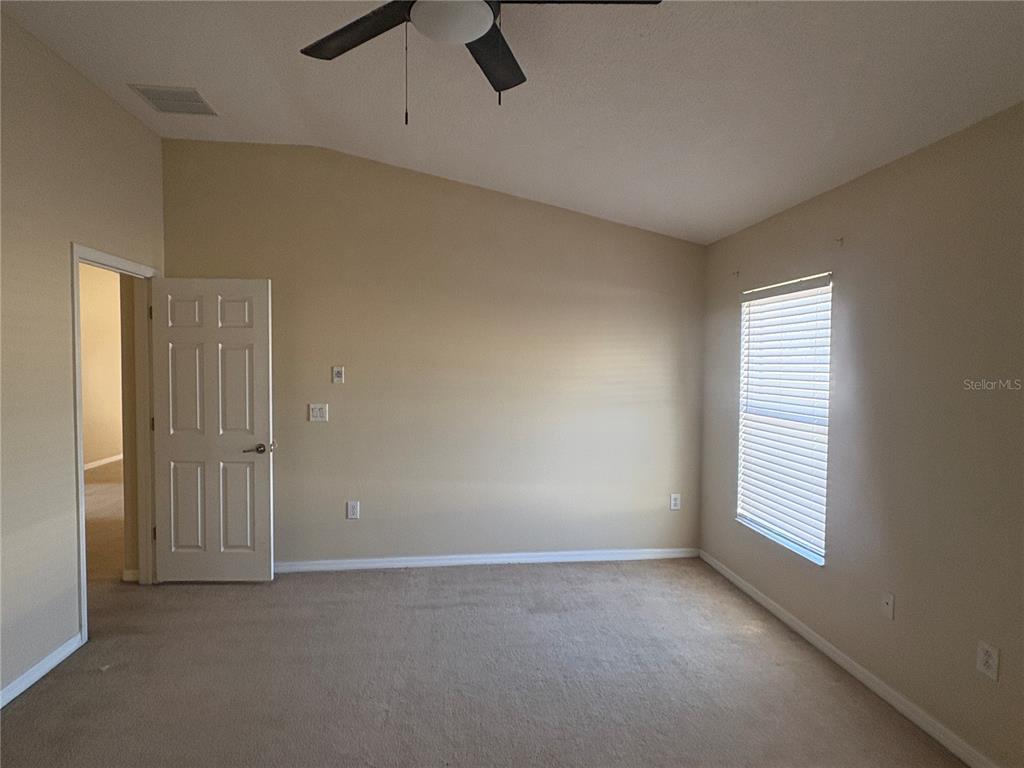 3878 Prescott Loop Lakeland, FL 33810 - Photo 9 of 12 an empty room with a window and a ceiling fan