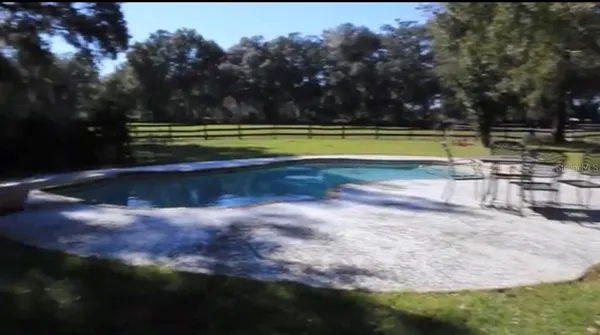 a view of a swimming pool and a yard