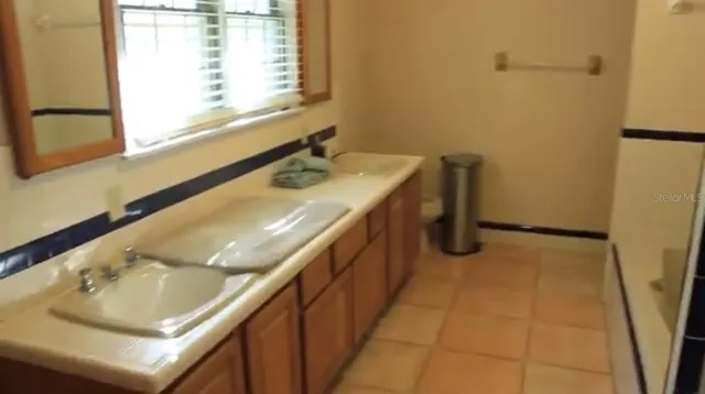 a bedroom with a bed and a night stand