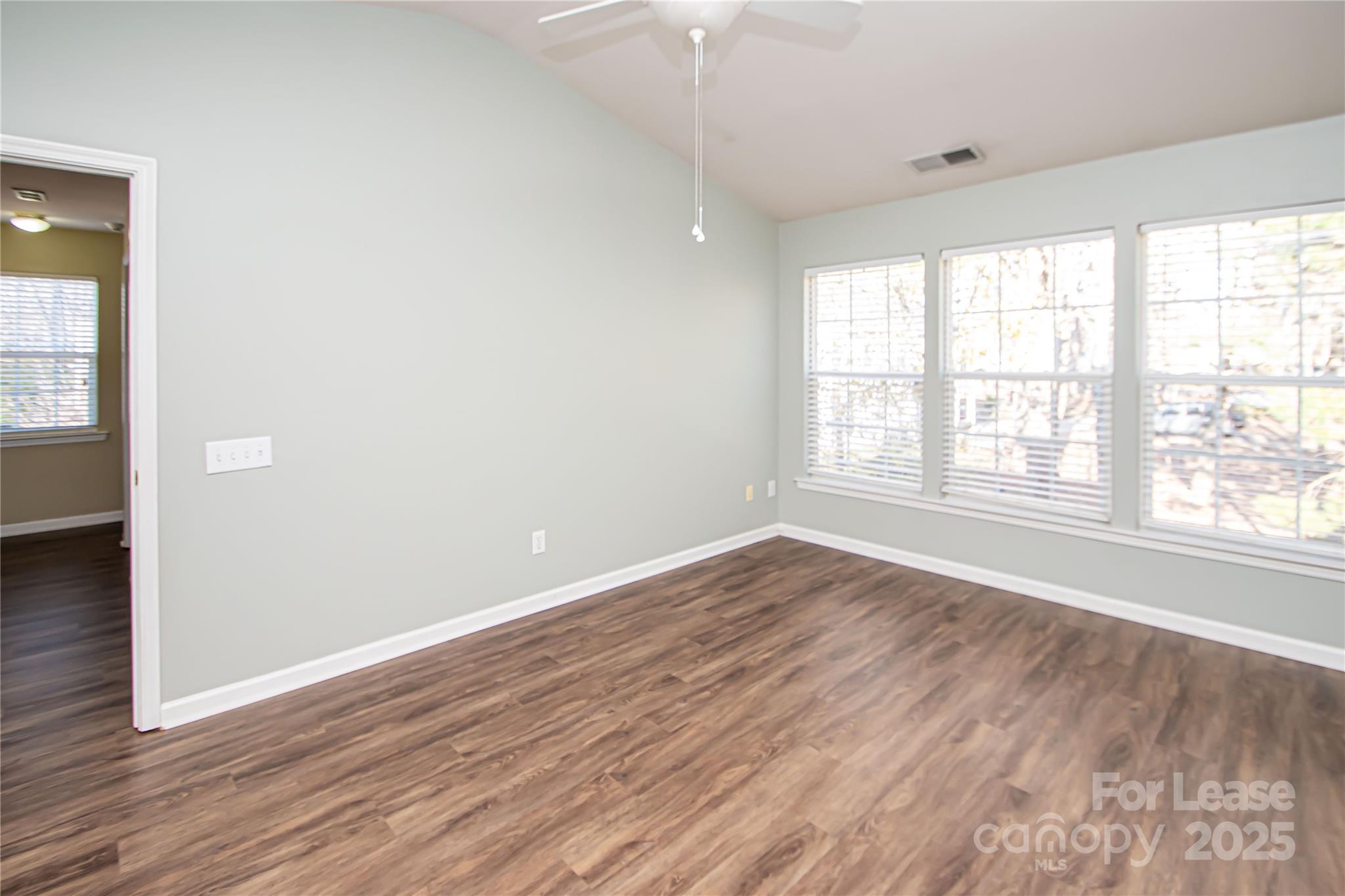 2121 Kaybird Lane Charlotte, NC 28270 - Photo 19 of 39 an empty room with wooden floor and windows