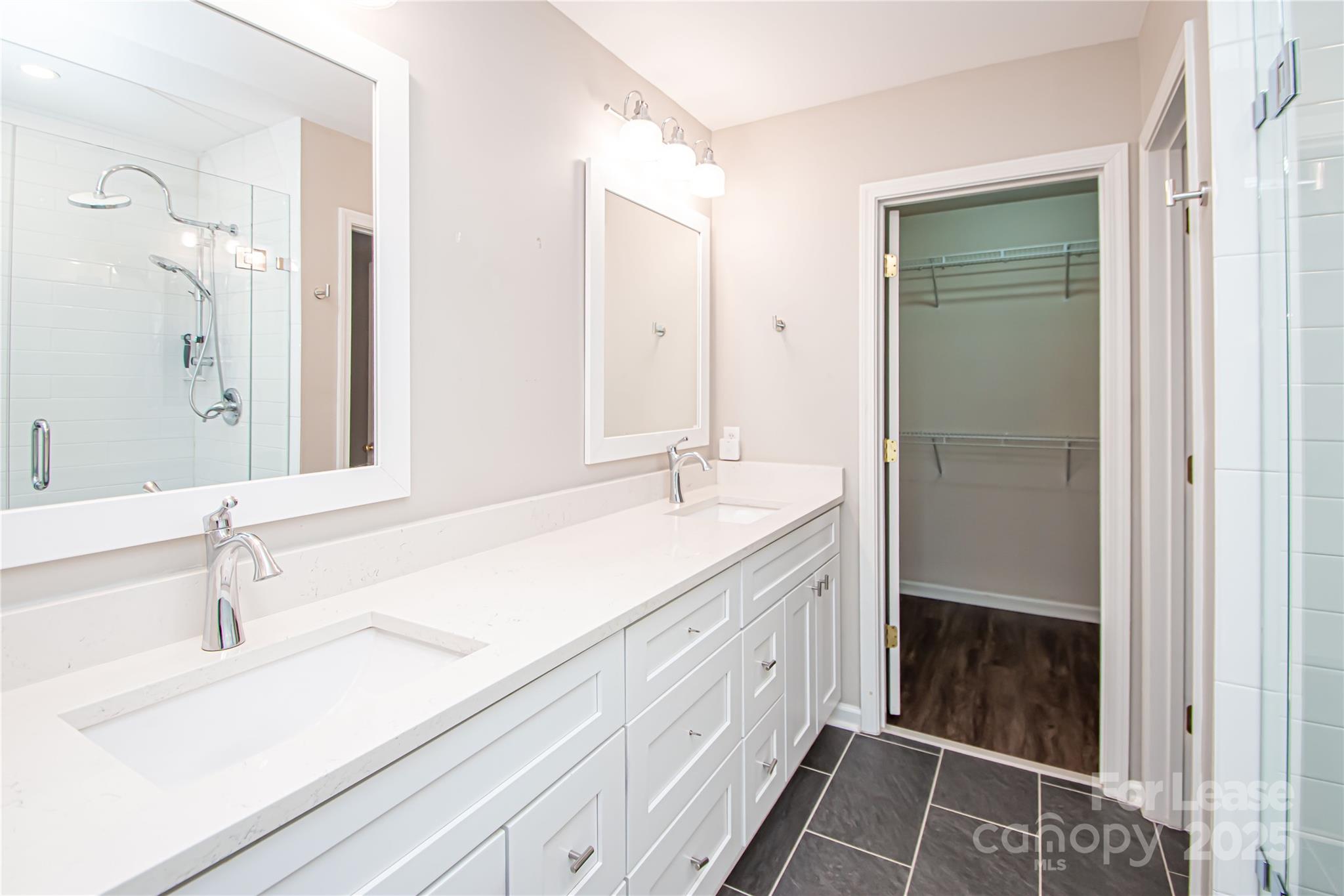 2121 Kaybird Lane Charlotte, NC 28270 - Photo 24 of 39 a bathroom with a double vanity sink and mirror