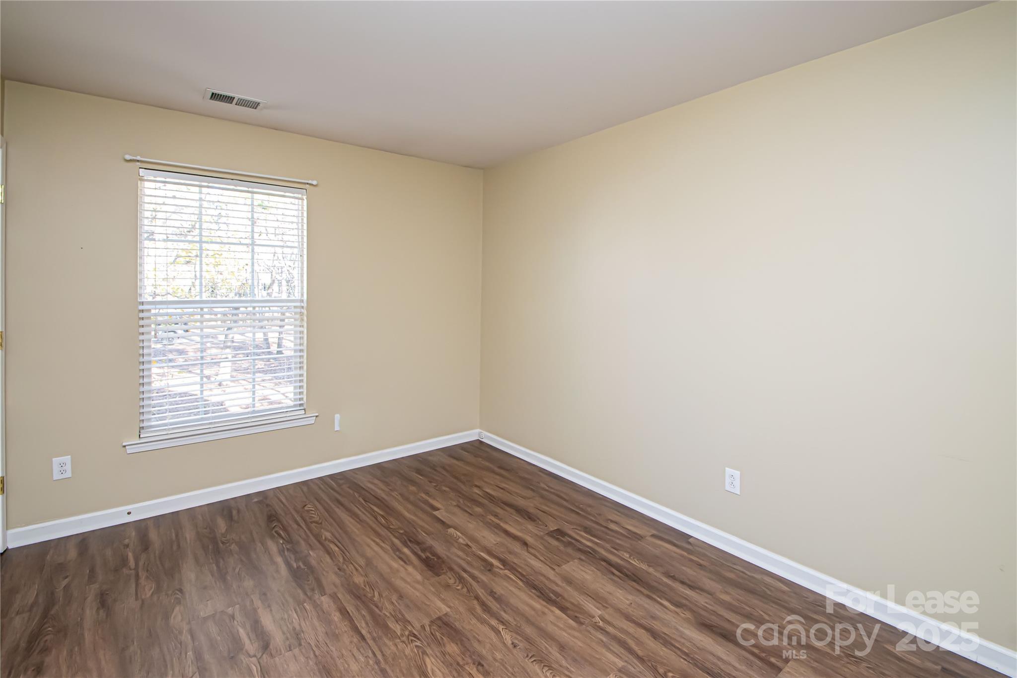 2121 Kaybird Lane Charlotte, NC 28270 - Photo 25 of 39 an empty room with wooden floor and windows