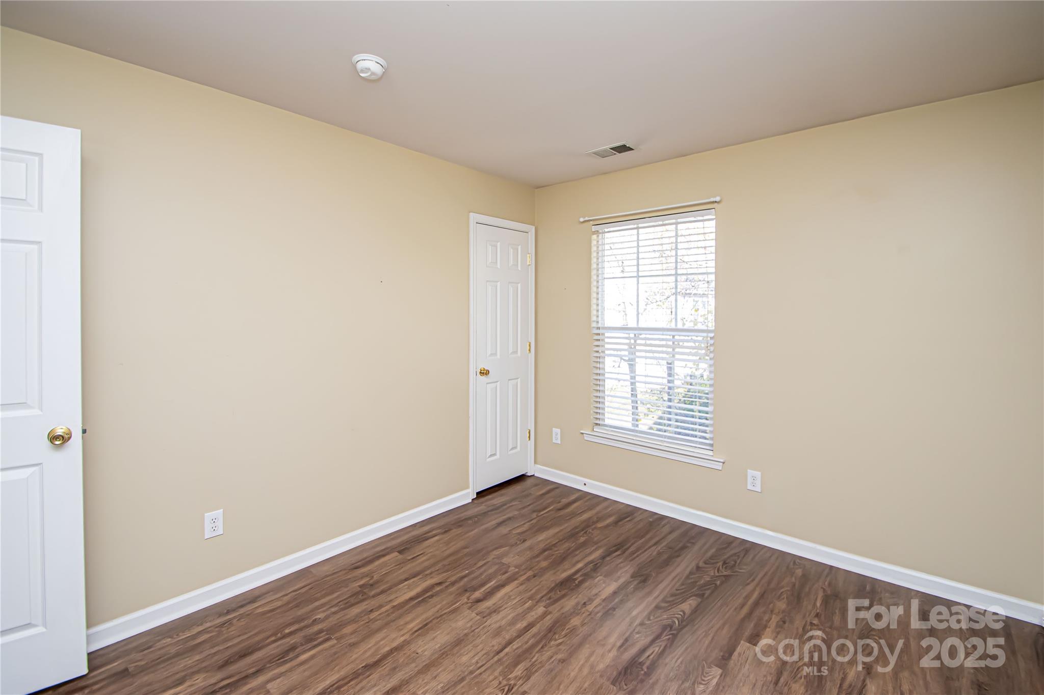 2121 Kaybird Lane Charlotte, NC 28270 - Photo 26 of 39 an empty room with wooden floor and windows