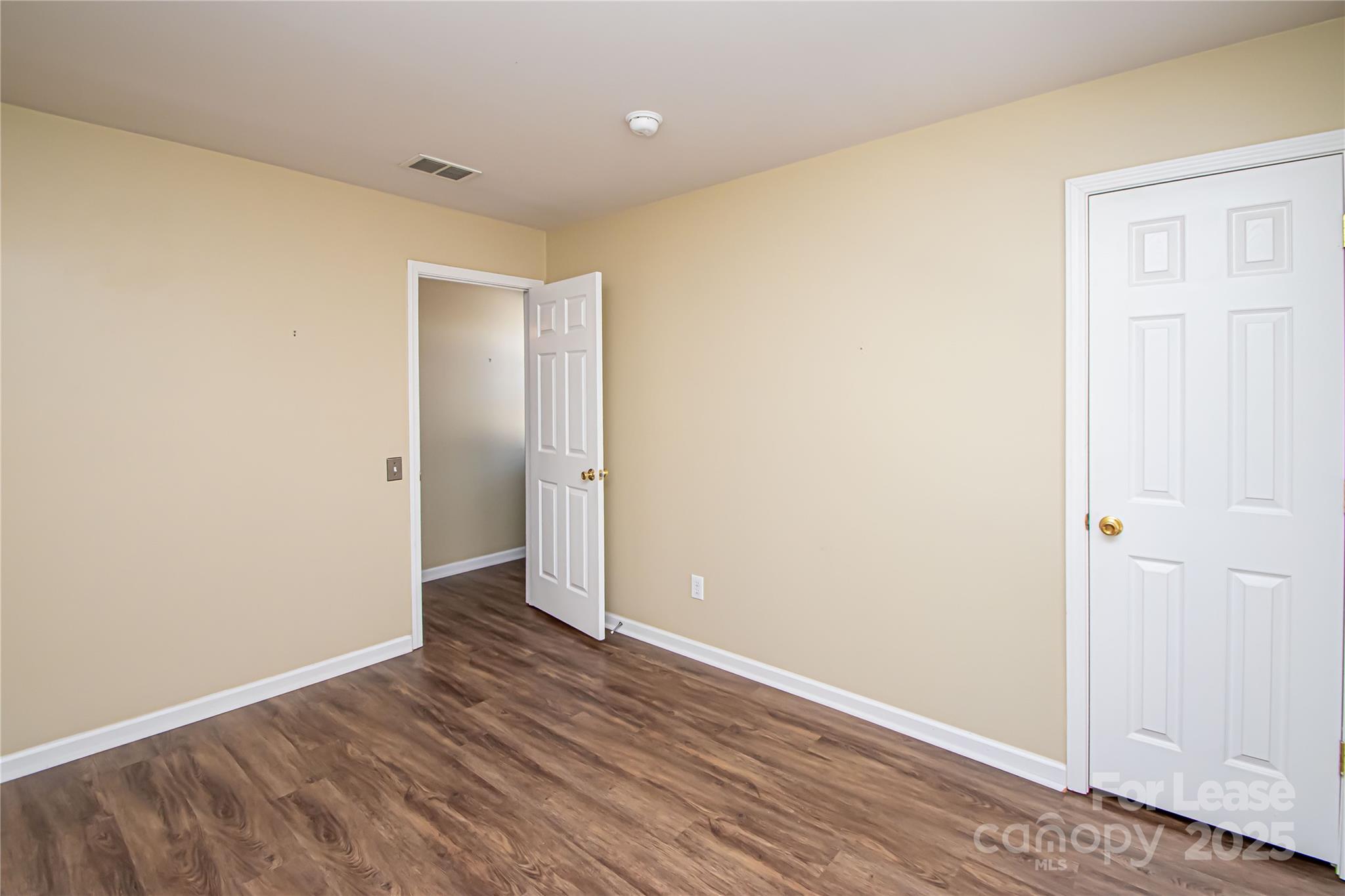 2121 Kaybird Lane Charlotte, NC 28270 - Photo 27 of 39 an empty room with wooden floor and closet