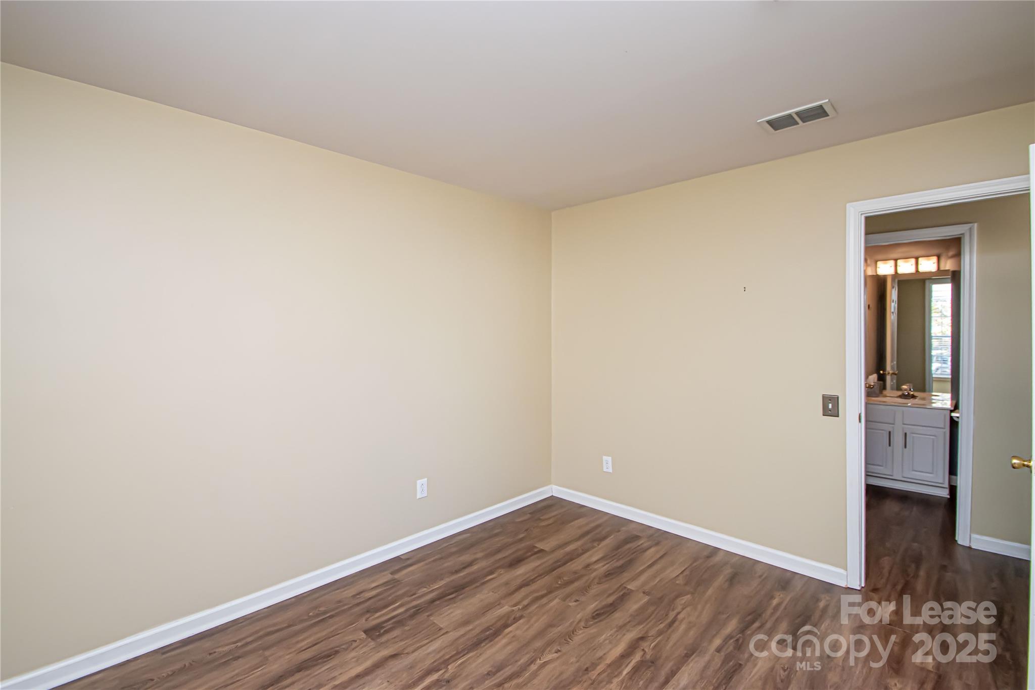 2121 Kaybird Lane Charlotte, NC 28270 - Photo 28 of 39 a view of an empty room with wooden floor and closet