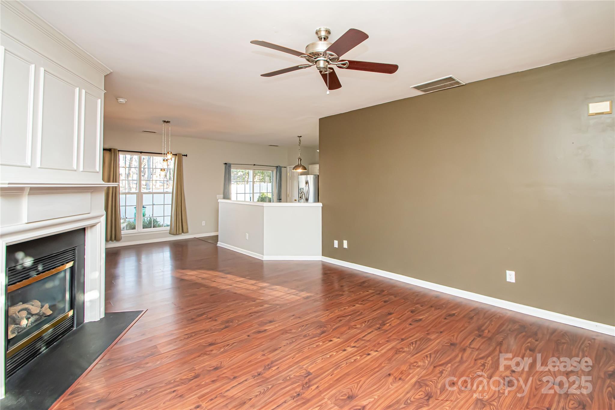 2121 Kaybird Lane Charlotte, NC 28270 - Photo 8 of 39 a view of an empty room with window and wooden floor